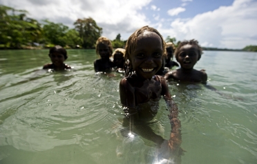 Children playing in the shallows, Solomon Islands